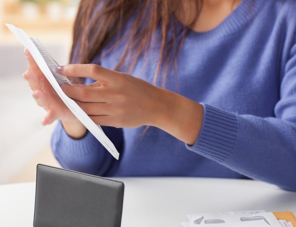 woman filling envelope